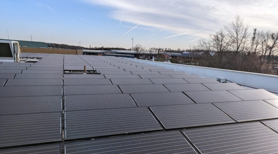 a rooftop covered in solar panels under a clear sky